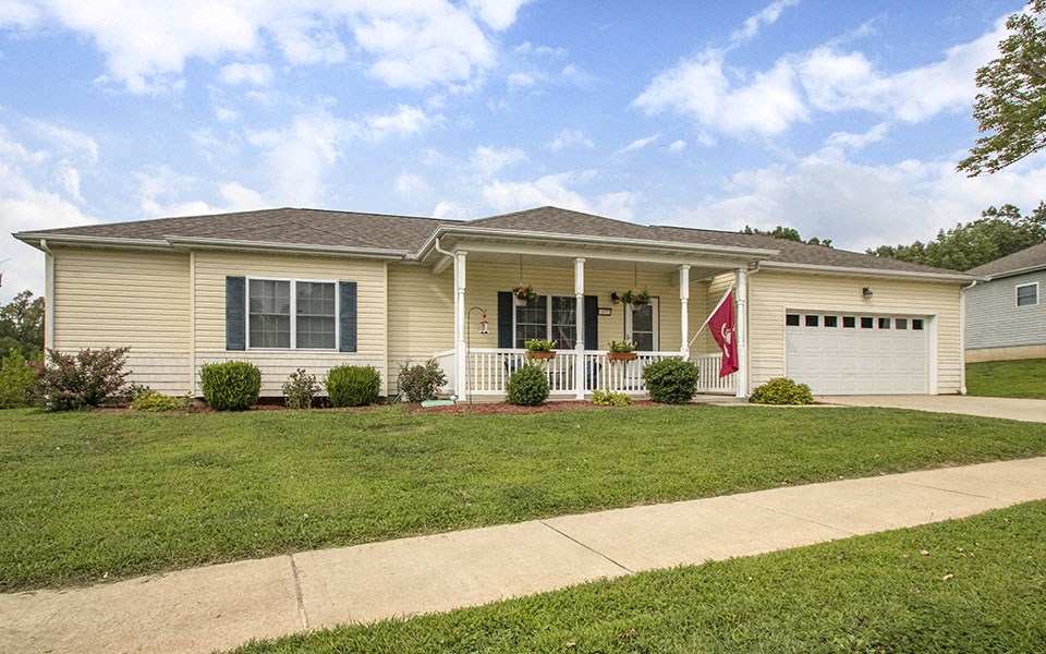 a yellow house with a flag on the front of it