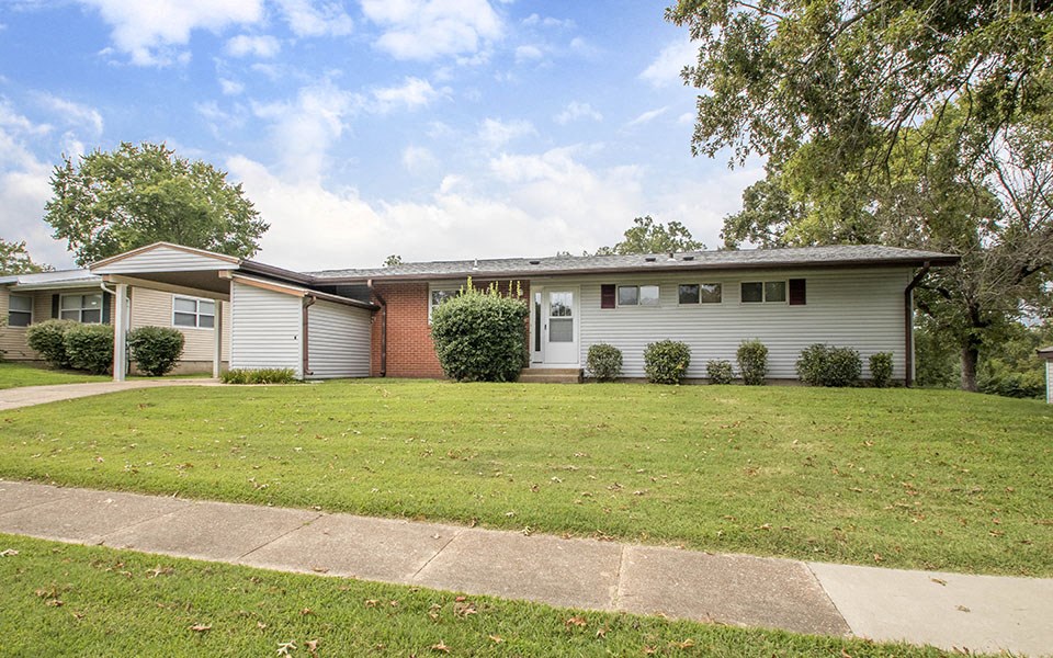 a white house with a lawn in front of it