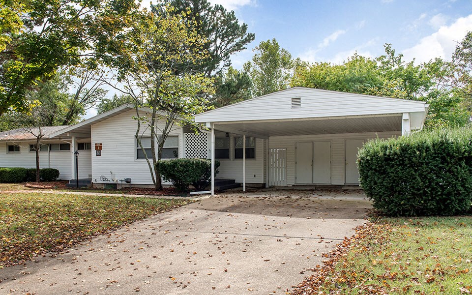 a white house with a driveway and a white garage door