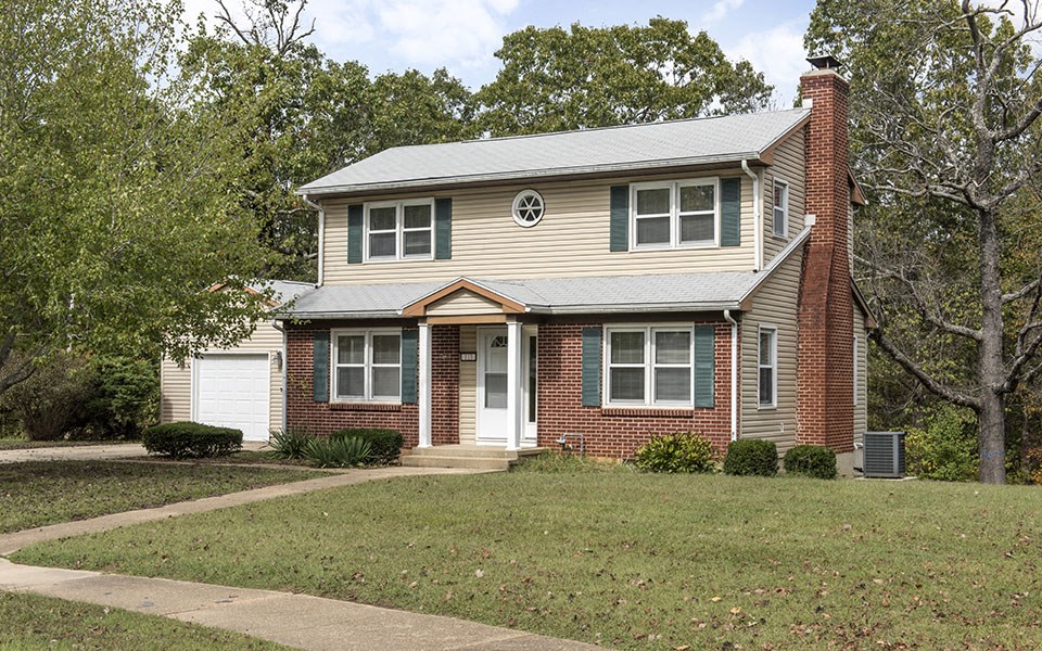 a house with a sidewalk in front of it