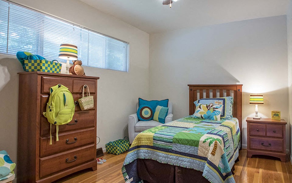 a bedroom with a bed and a dresser