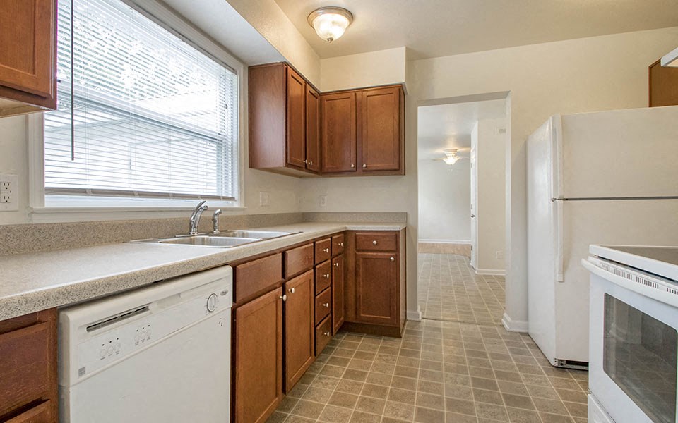 a kitchen with a sink and a refrigerator