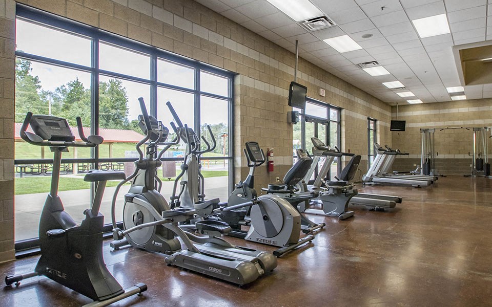 a gym with treadmills and other exercise equipment
