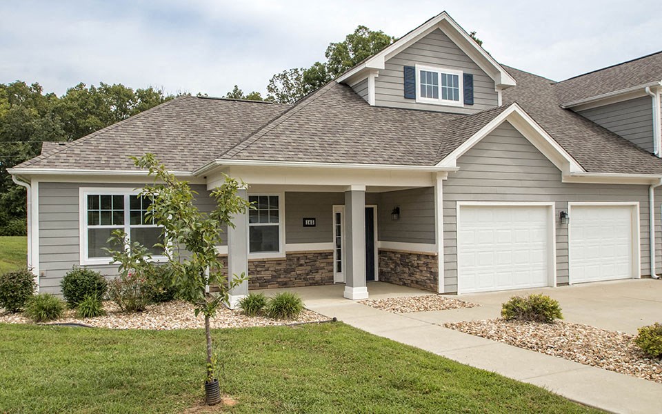 a house with a driveway and a garage door