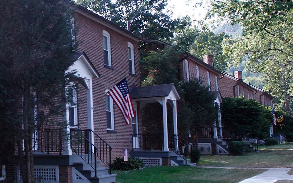 a brick house with an flag in front of it