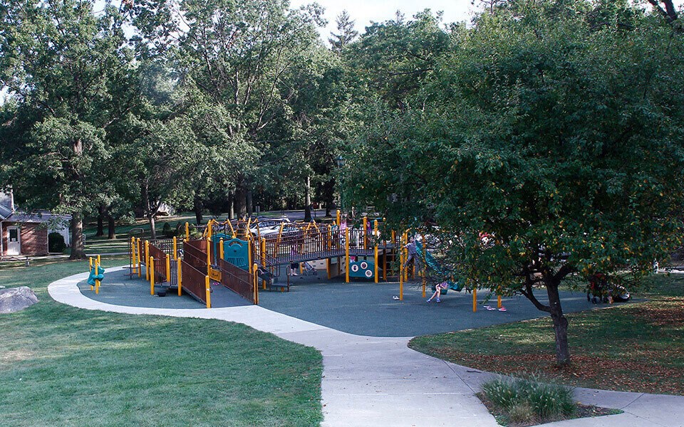 a playground in a park with kids playing on it