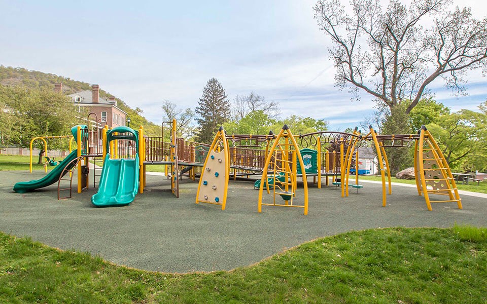 a playground with slides and other toys in a park