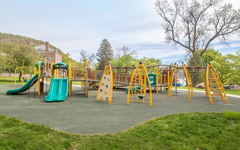 a playground with slides and other toys in a park
