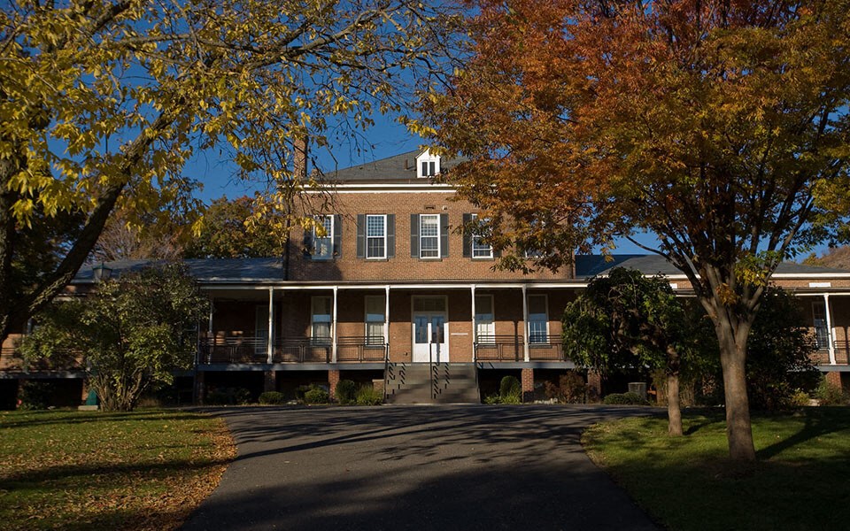 the front of a building with trees in front of it