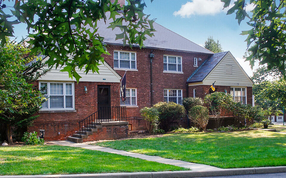 a brick house with a lawn in front of it