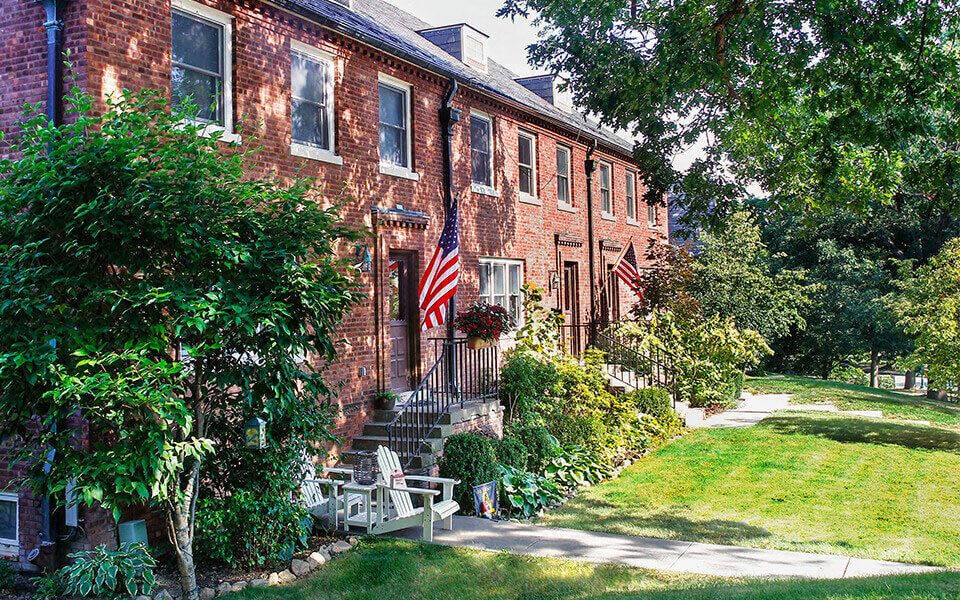 a red brick house with an flag on the front