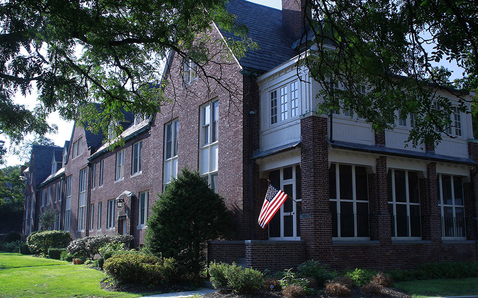 an flag in front of a brick house