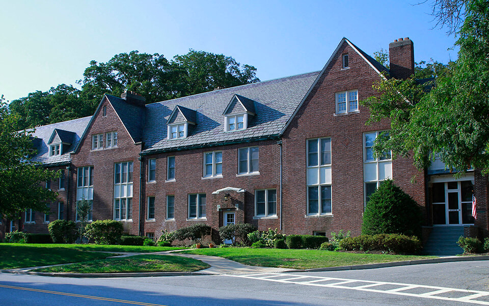 a large brick house with a street in front of it