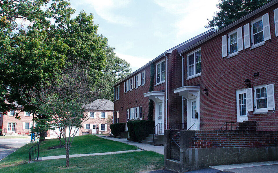 a large brick building with trees in front of it