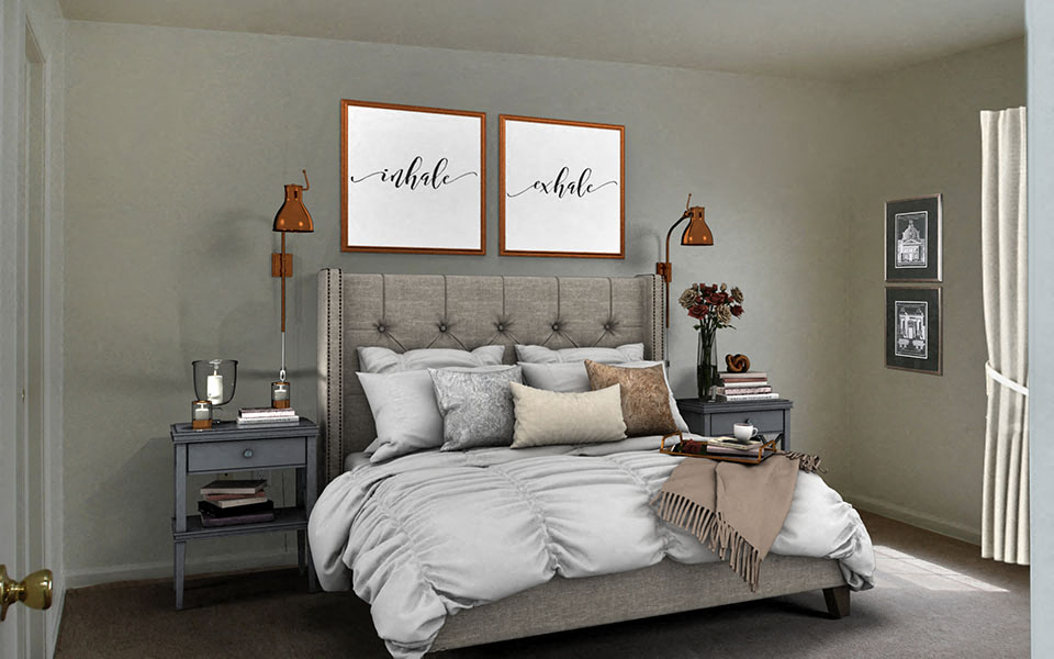 a bedroom with a bed and two paintings on the wall