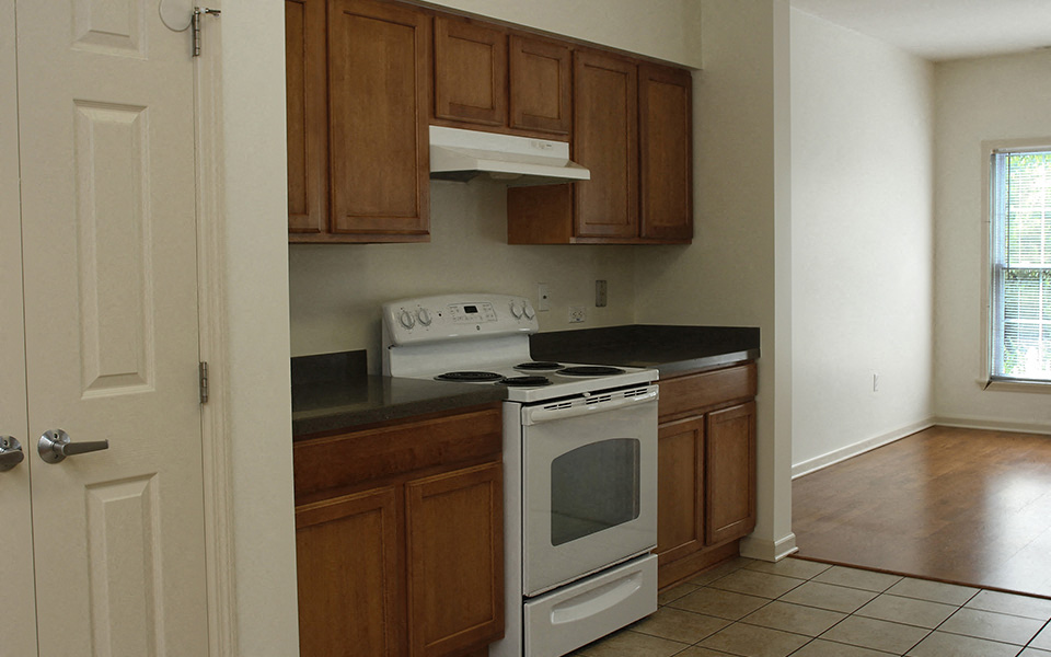 a kitchen with white appliances and wooden cabinets
