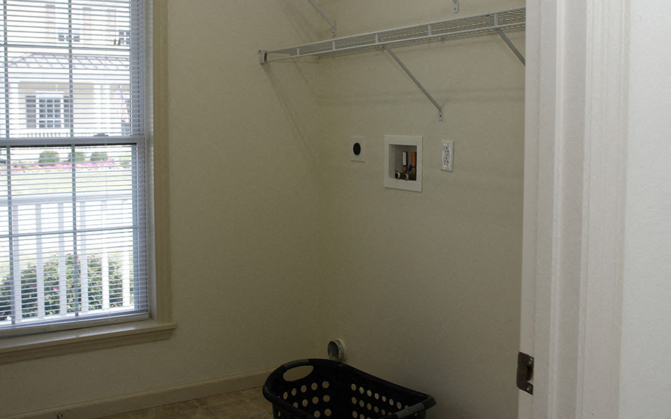 a room with a closet and a window and a baby chair