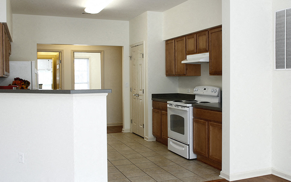 a kitchen with white appliances and wooden cabinets