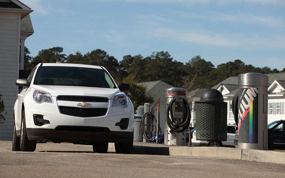 a white car parked at a gas station