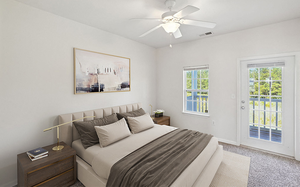 A bedroom with a large bed and a painting on the wall.