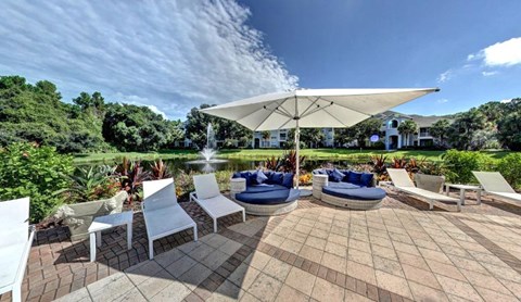 Swimming Pool Area With Shaded Chairs at Tuscany Bay Apartments, Tampa, FL, 33626
