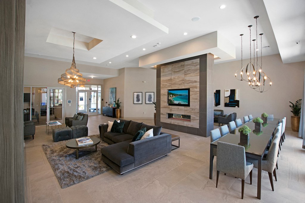 a living room and dining room with a table and chairs