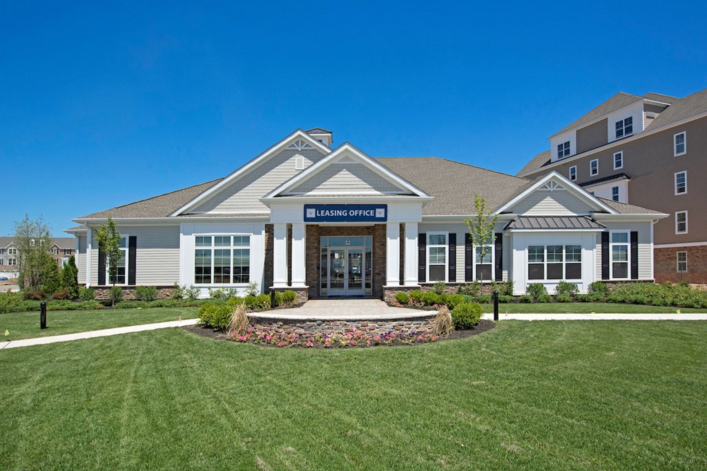 a large building with a lawn in front of it
