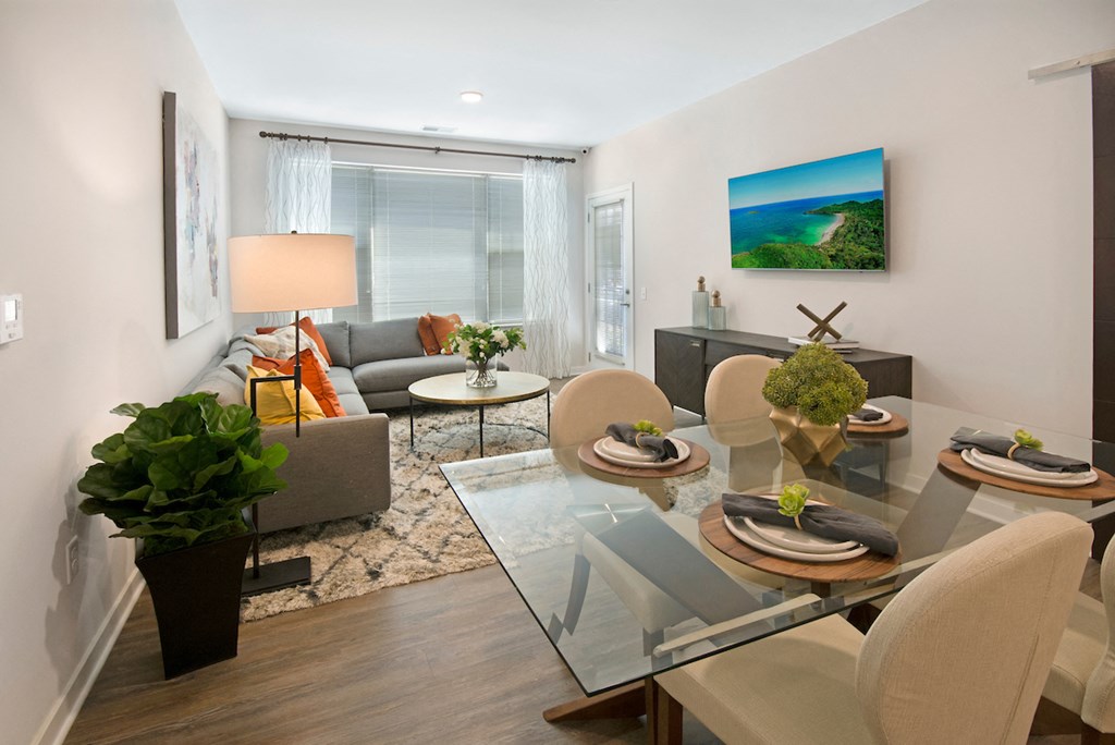 a living room and dining room with a glass table