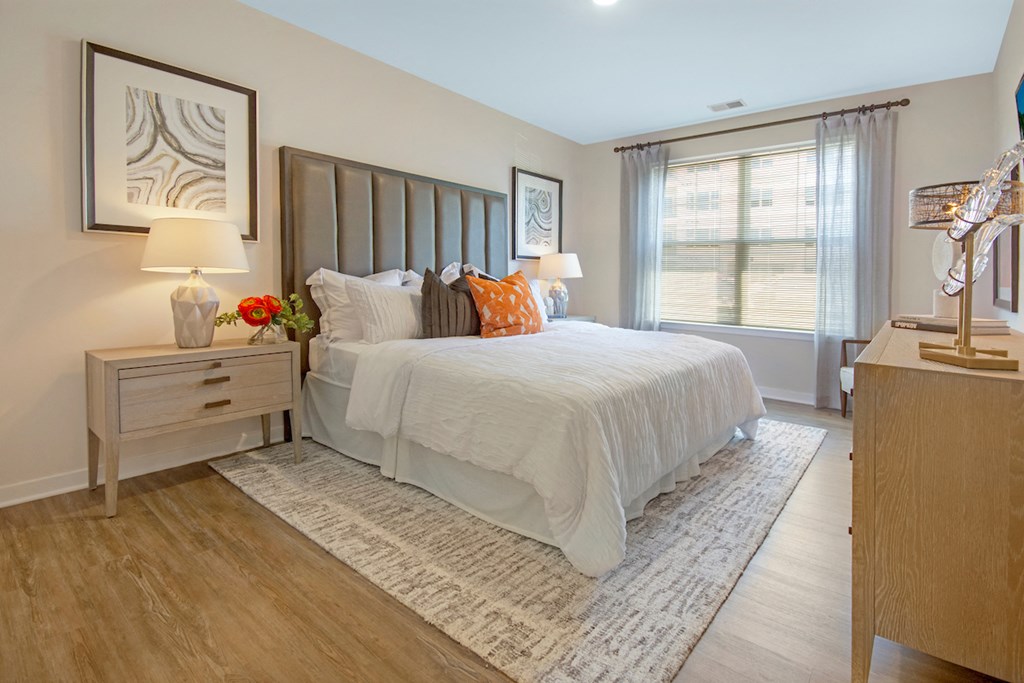 a bedroom with a large bed and a window