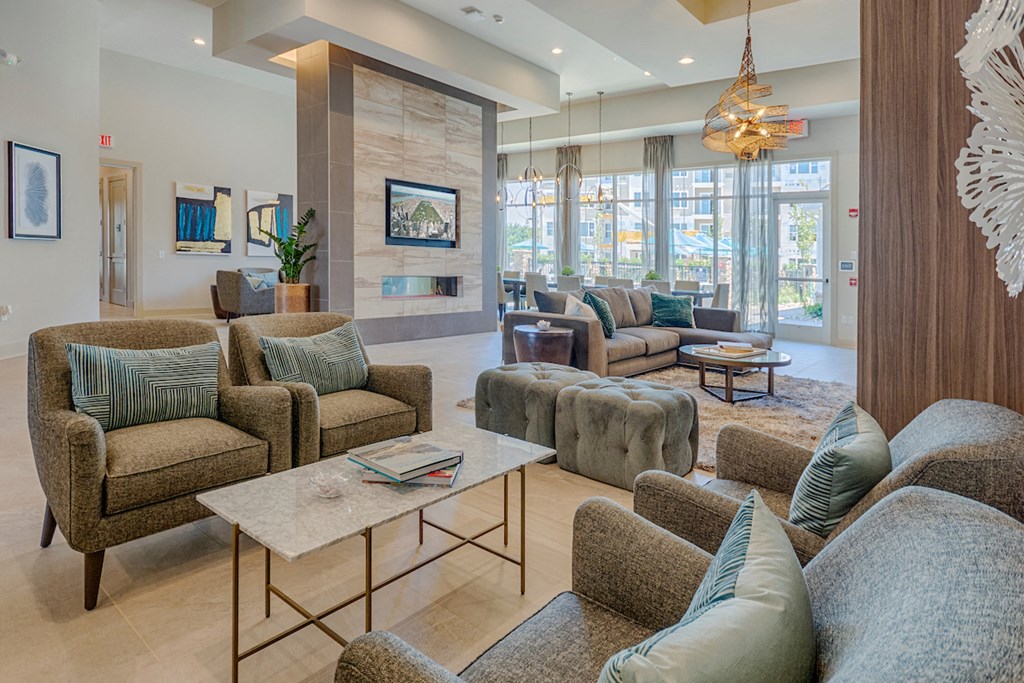 a living room with couches and chairs and a fireplace