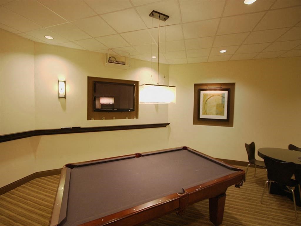 a game room with a pool table and a tv
