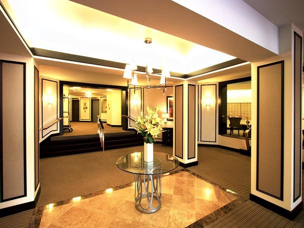 a lobby with a table and a vase with flowers