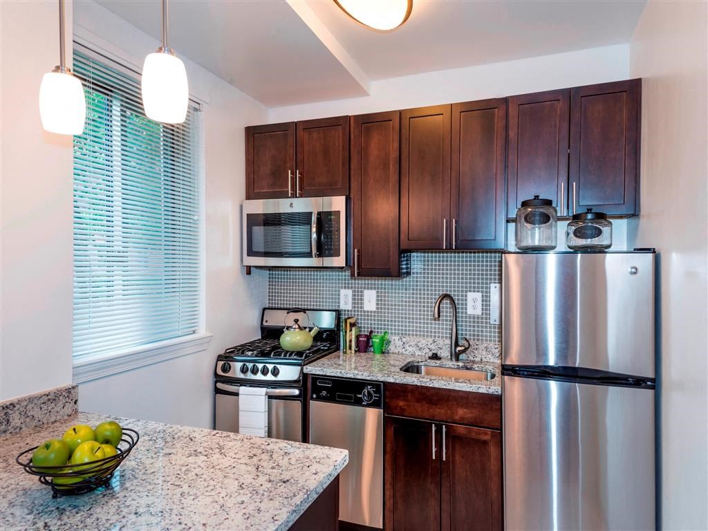 a kitchen with stainless steel appliances and a counter top