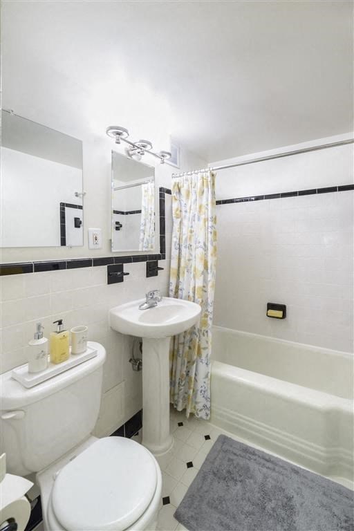 a white bathroom with a sink toilet and tub