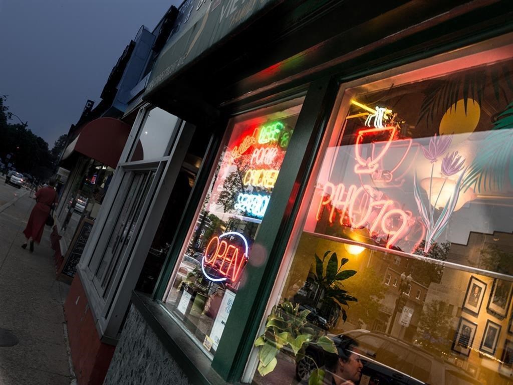 a window of a restaurant at night with neon signs
