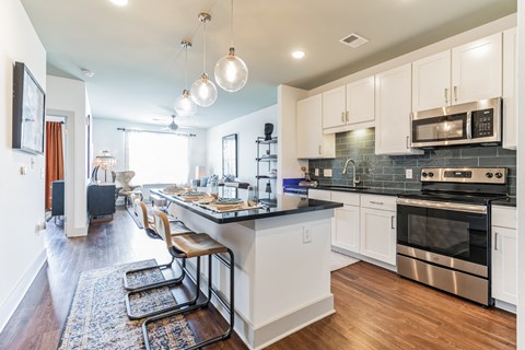 a kitchen with a large island and stainless steel appliances