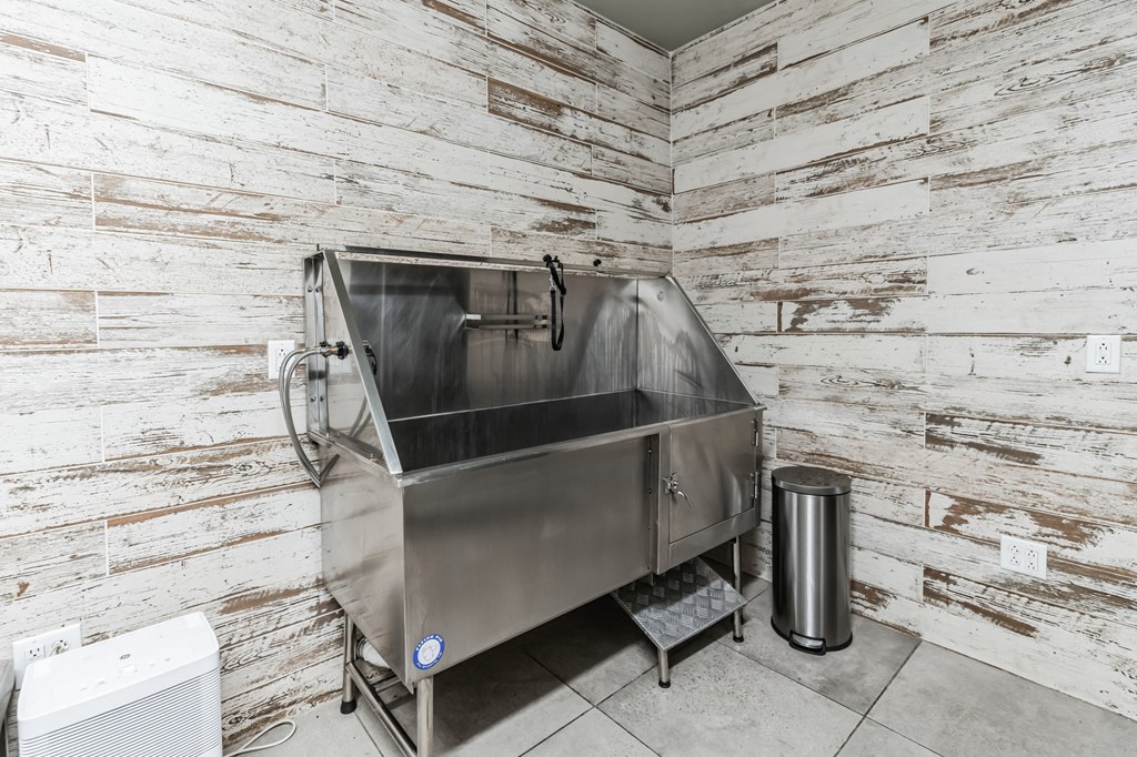 a large stainless steel sink in the corner of a room