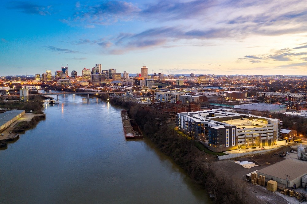 an aerial view of a river with a city in the background