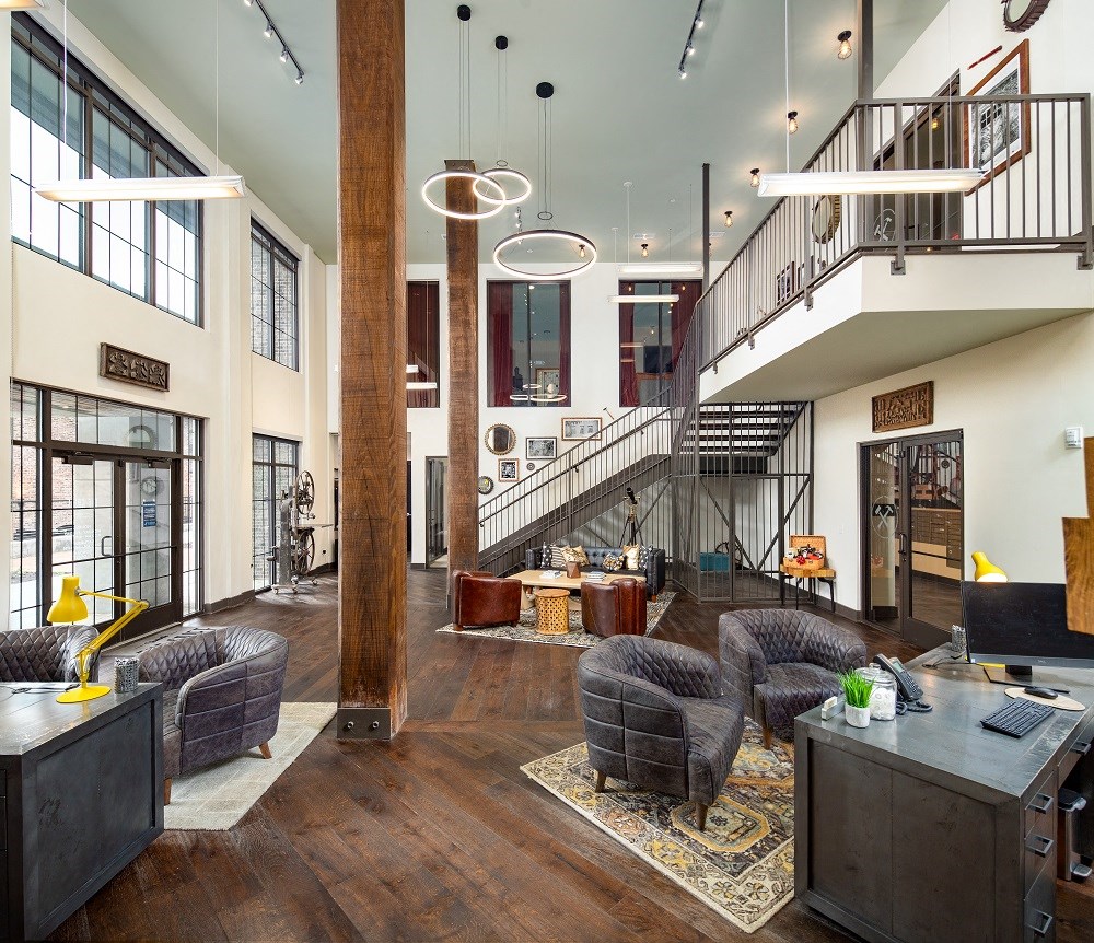 a large living room with furniture and a staircase