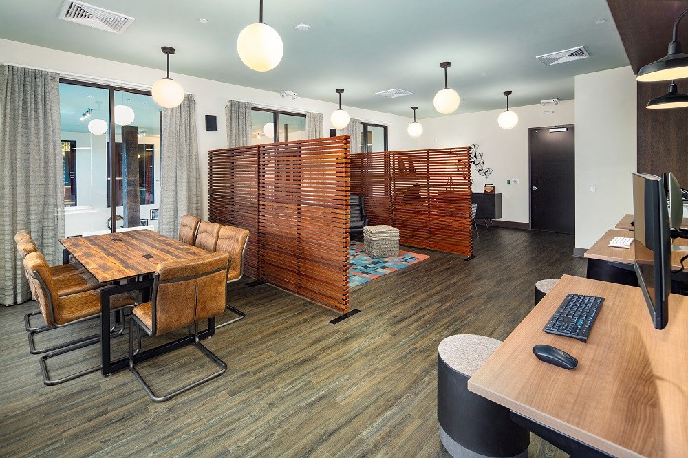 a large room with a table and chairs and a computer