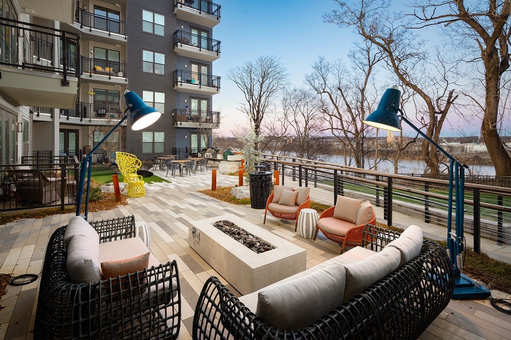 an outdoor living area with furniture and a fire pit