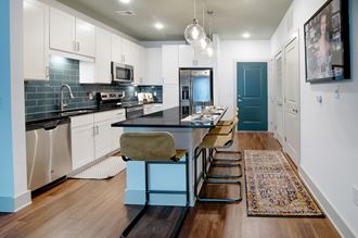 a kitchen with a long island and a blue and black counter top