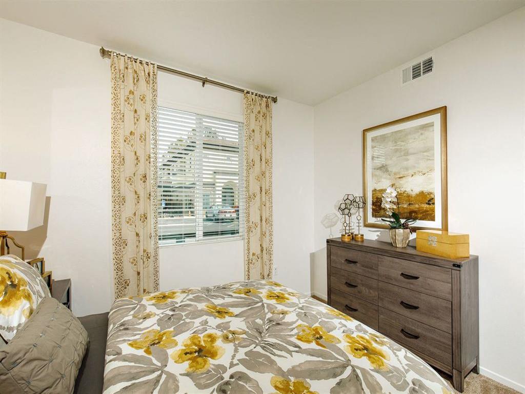 Master bedroom with a window on the left and can fit a queen bed with 2 nightstands and a dresser