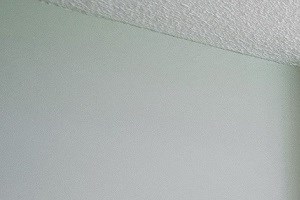 an empty living room with white walls and carpet