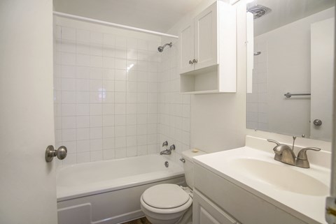 a bathroom with a sink toilet and a bath tub