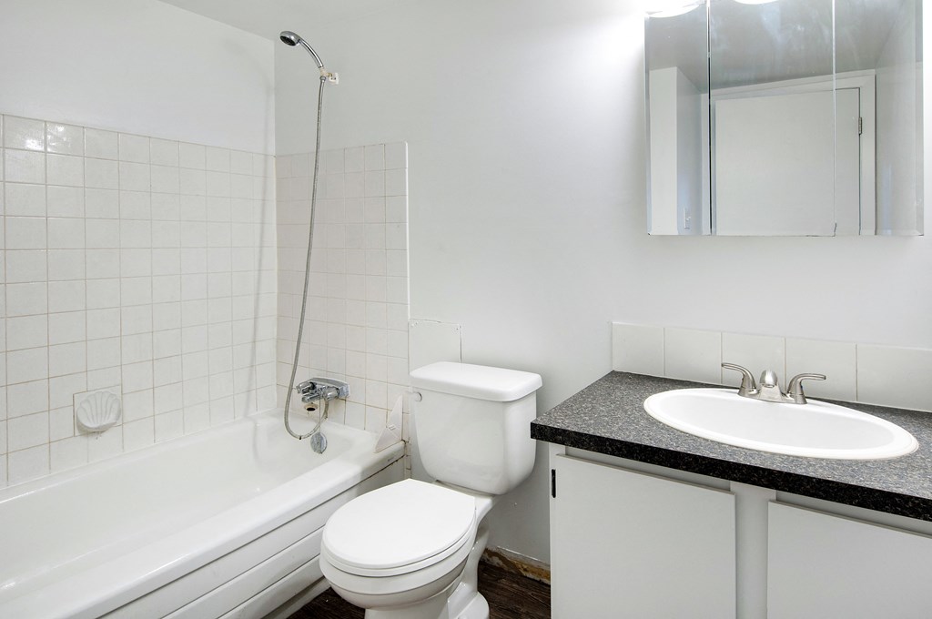 a white bathroom with a sink toilet and tub