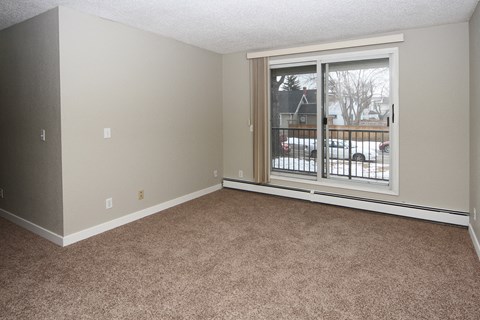 an empty living room with a large window
