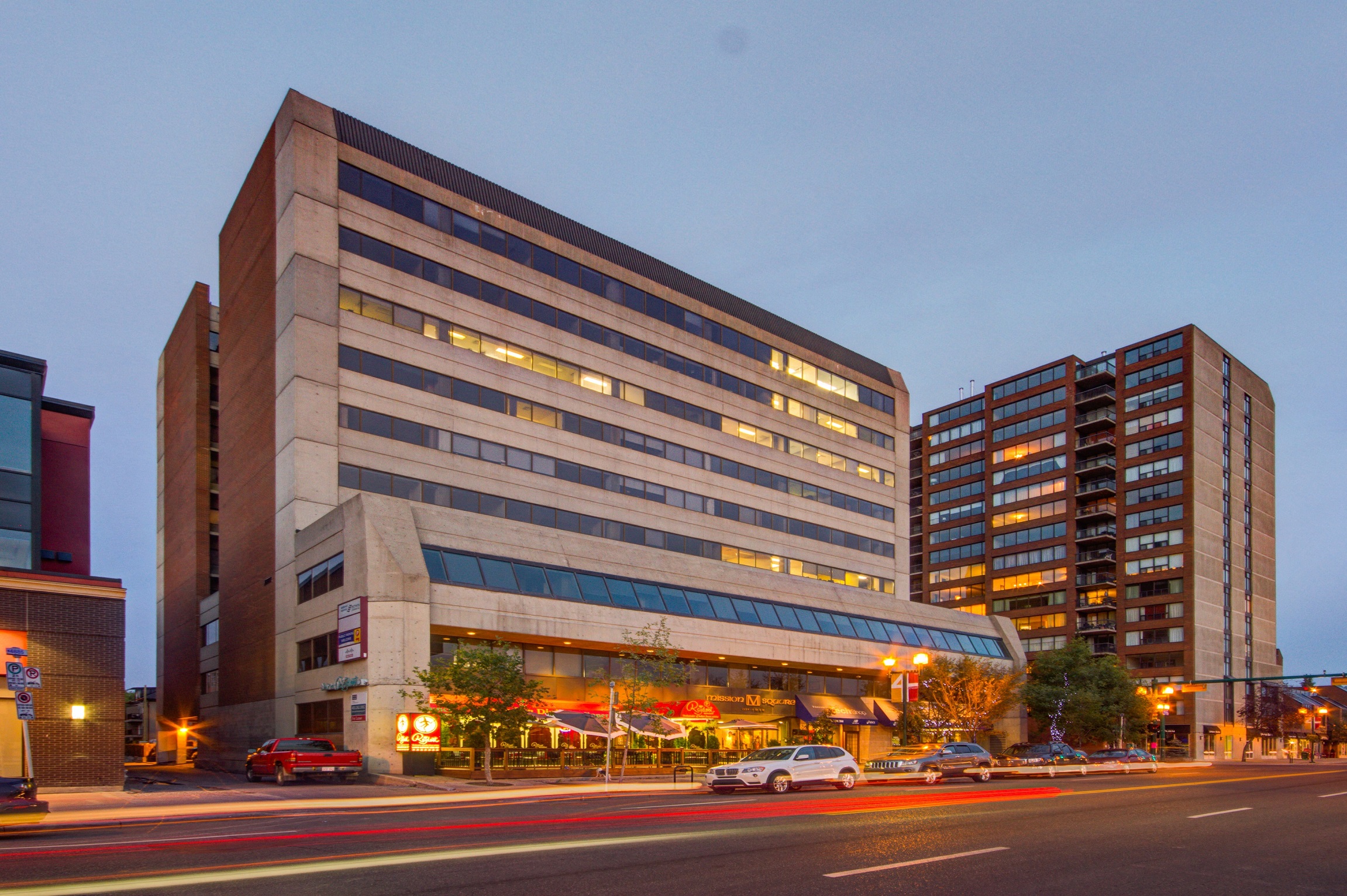 an evening view of an office building on a city street