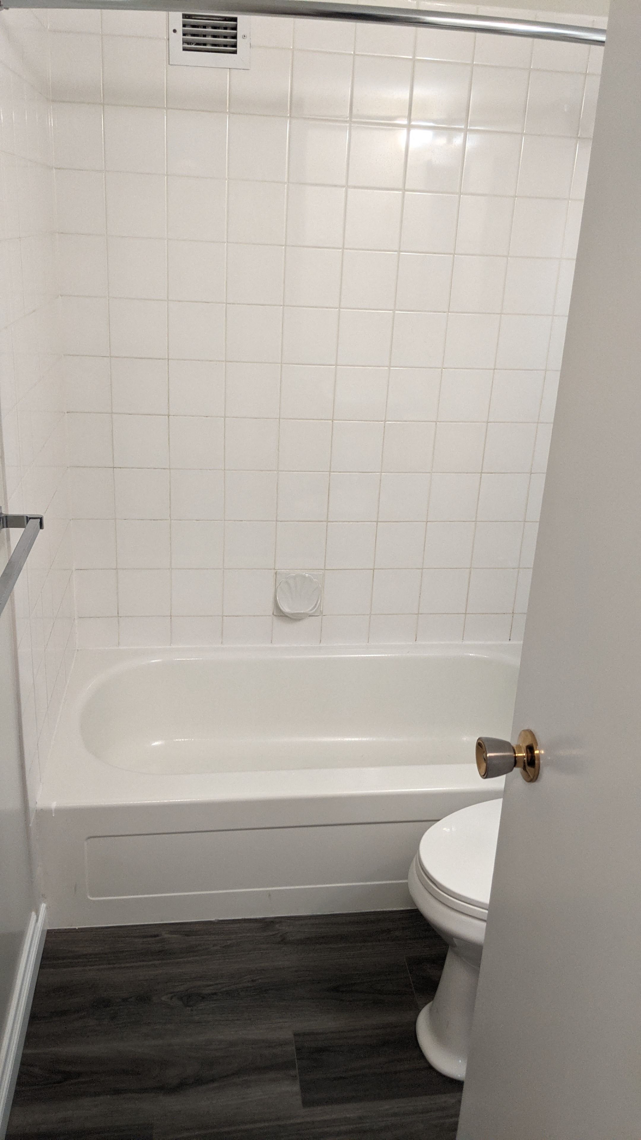 a small bathroom with a tub and a toilet