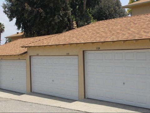 Two garage doors are closed and numbered 1124 and 1122.